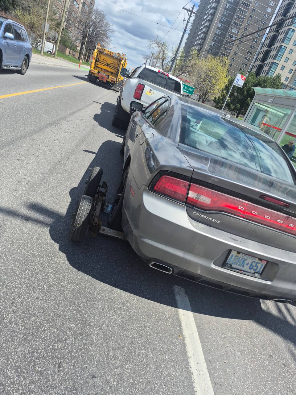 TowMania flatbed towing a Dodge Charger on an Ottawa arterial road