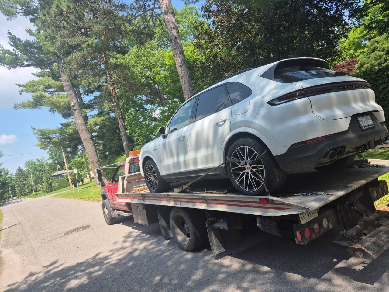TowMania flatbed safely transporting a white Porsche Cayenne in an Ottawa suburb
